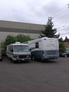 Two rv trucks parked beside each other