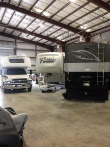 Three rv trucks in garage